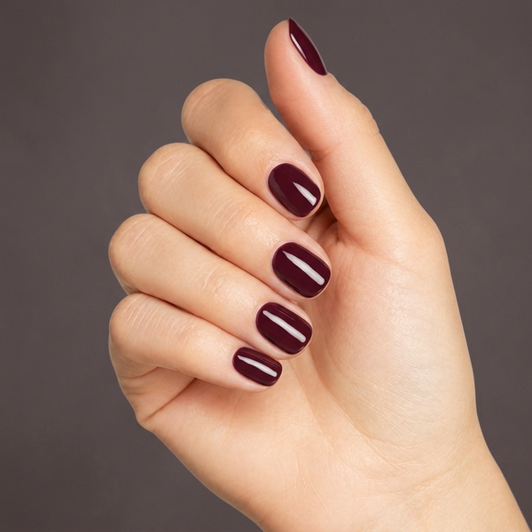 Mano con las uñas pintadas con esmalte en gel Gelish Looking For a Wingman, color Borgoñas acabado Cream