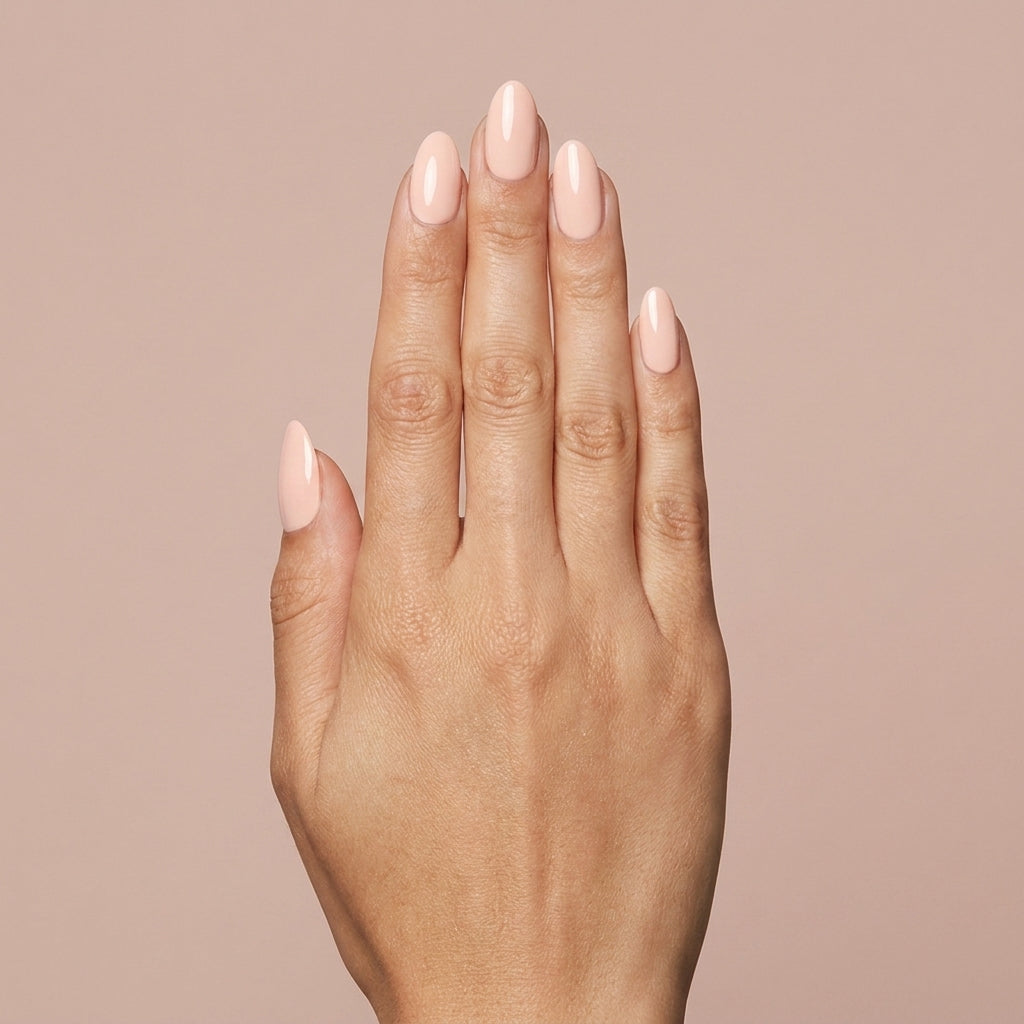 Mano con las uñas pintadas con esmalte en gel Gelish Barely Buff, color Nudes acabado Cream