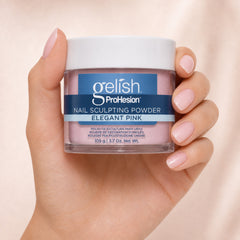 Mano sosteniendo polvo acrílico Gelish ProHesion Nail Sculpting Powder Elegant Pink